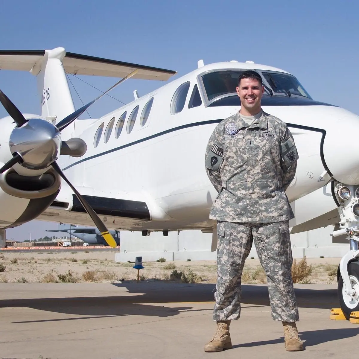 Jason R. Todd in U.S. Army uniform beside an aircraft